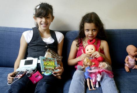 Moving on ... Helena Hampshire, 10, left, and sister Ava, 5, with their favourite toys