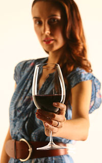 A woman holding a glass of wine.