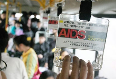 A Chinese passenger holds a grab handle with AIDS prevention information, on a bus in Changsha, in China's central Hunan province, in this March 23, 2006, file photo. Chinese state media said Tuesday November 22, 2006, that reported cases of HIV/AIDS have jumped 30 percent in 2006, compared to the year previous, with drug use the main source of infection. (AP 