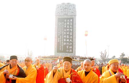 Monks attend the completion ceremony of the Giant Bell and Stele Garden at the Hanshan Temple in Suzhou, east China's Jiangsu Province, Dec. 30, 2008.