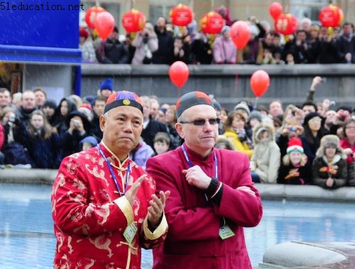 Two men in Chinese traditional costume enjoy the performances during a celebration of Chinese Lunar New Year in London, capital of Britain, Feb. 21, 2010. Grand Chinese Lunar New Year celebrations were held in Trafalgar Square, Leicester Square and Chinatown in London on Sunday, providing a spectacular Chinese traditional festival experience to locals and visitors alike.